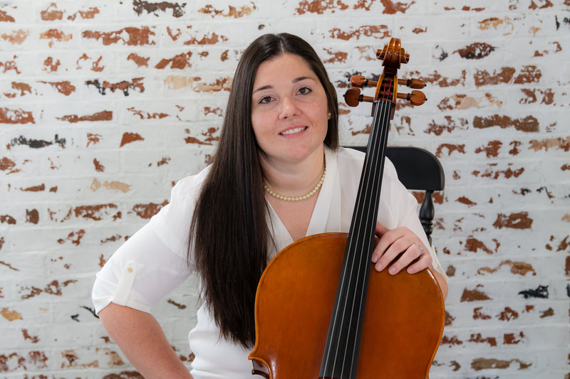 Smiling cellist posed with instrument